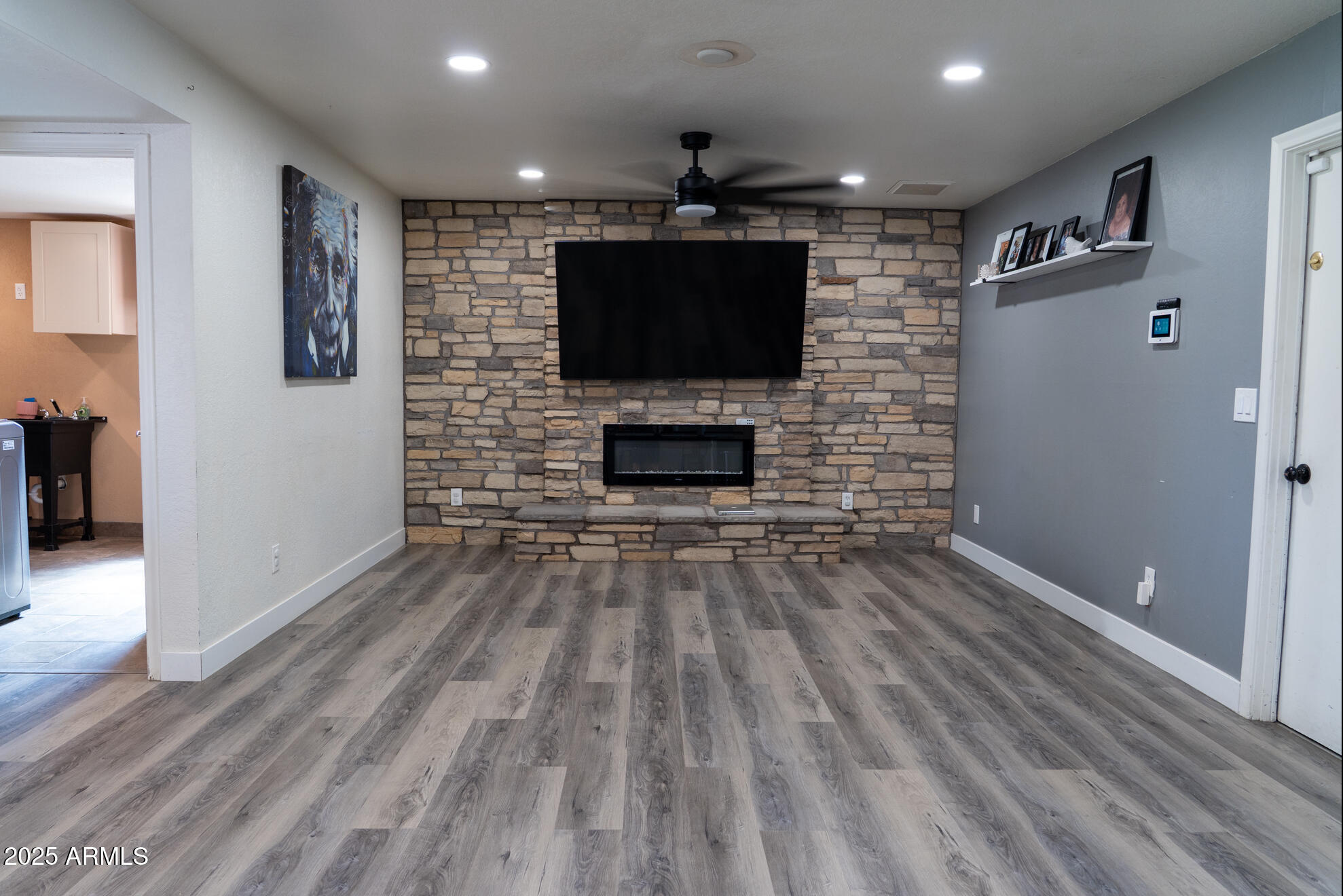 3102 West Paradise Drive Phoenix, AZ 85029 - Photo 8 of 22 a living room with a flat screen tv and a fireplace