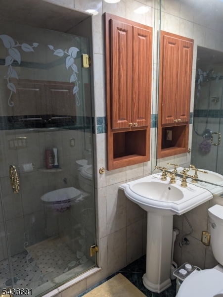 178 East Lindsley Road, Unit 2 Cedar Grove, NJ 07009 - Photo 19 of 28 a bathroom with a sink a toilet and shower