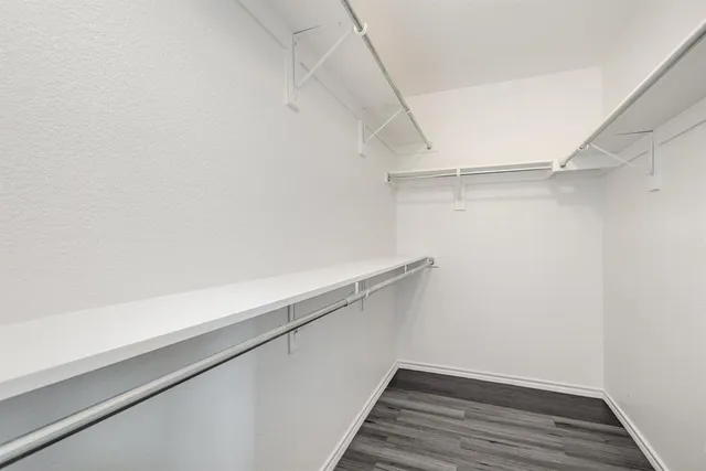 a view of a room with wooden floor