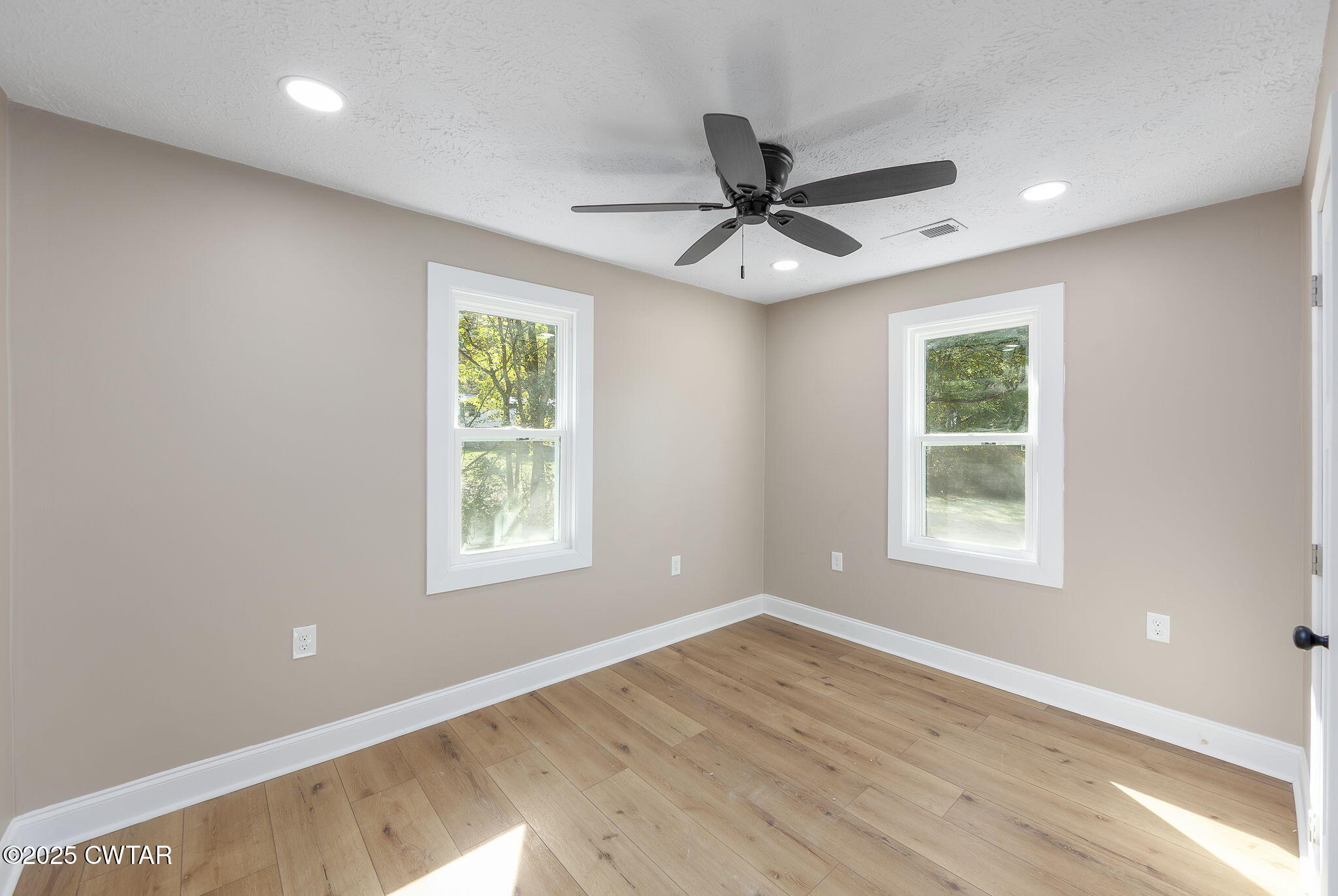 424 Rozelle Street Gibson, TN 38343 - Photo 13 of 20 a view of an empty room with wooden floor and a window