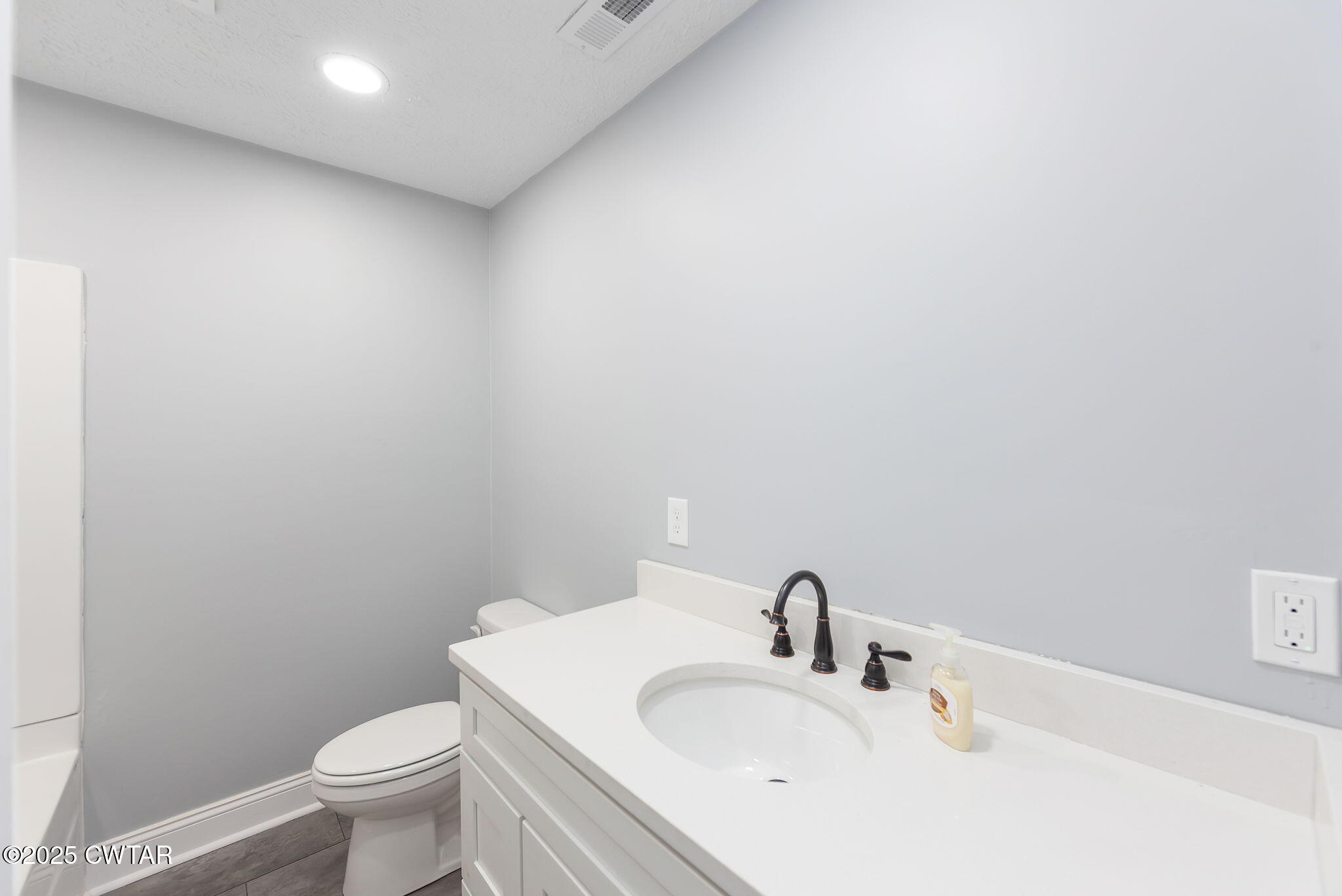 424 Rozelle Street Gibson, TN 38343 - Photo 14 of 20 a bathroom with a sink and a toilet