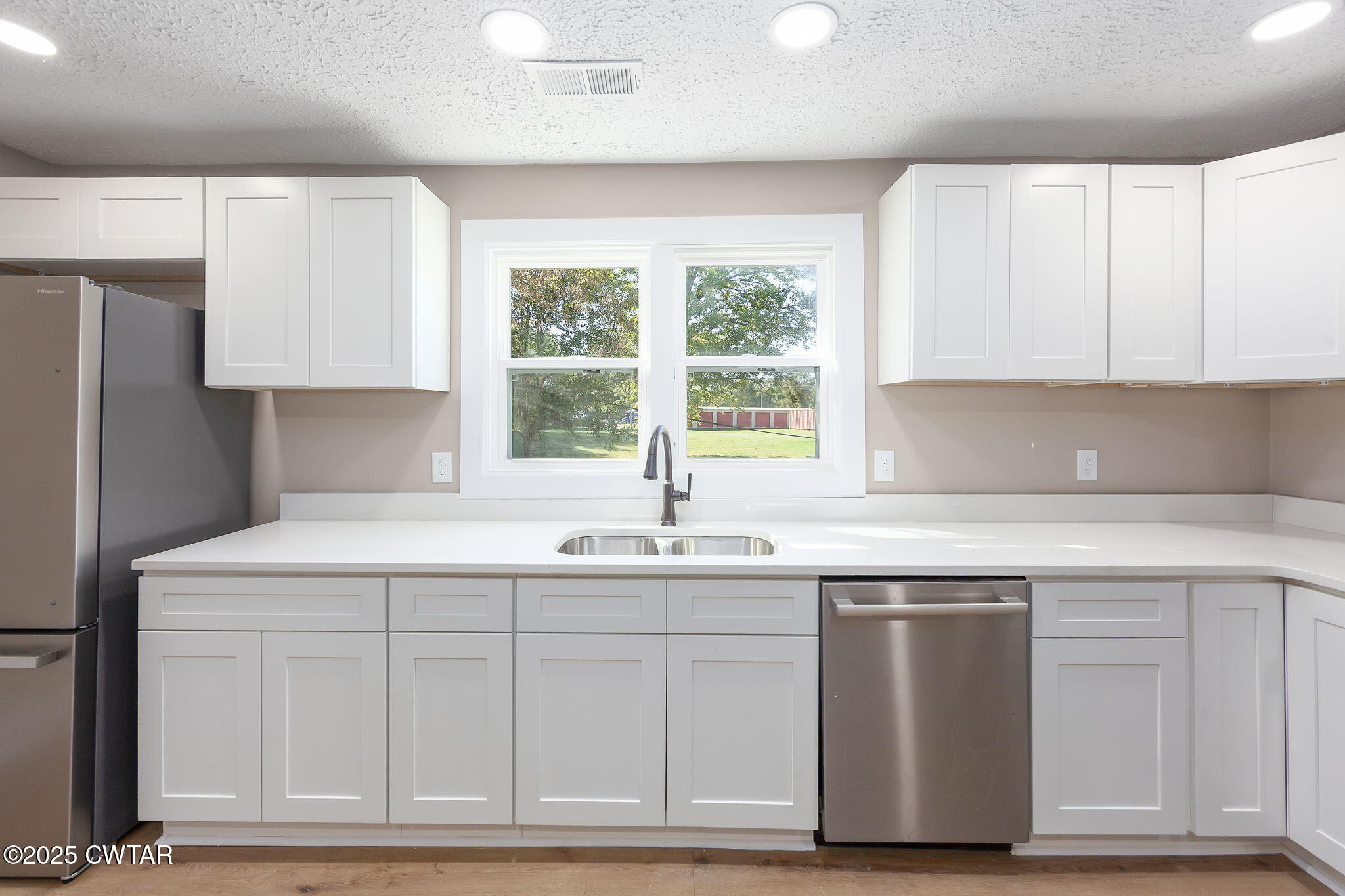 424 Rozelle Street Gibson, TN 38343 - Photo 7 of 20 a kitchen with white cabinets and sink