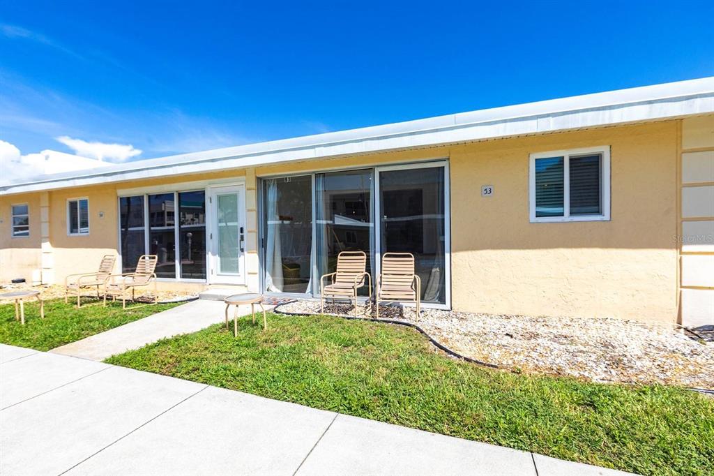 6006 Midnight Pass Road, Unit 53 Sarasota, FL 34242 - Photo 11 of 20 a view of a house with backyard and sitting area