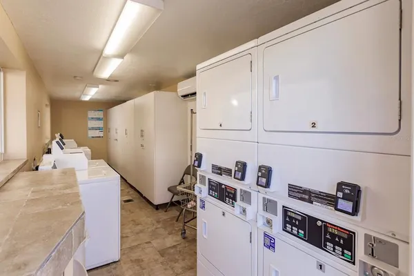 a view of kitchen and utility room with refrigerator