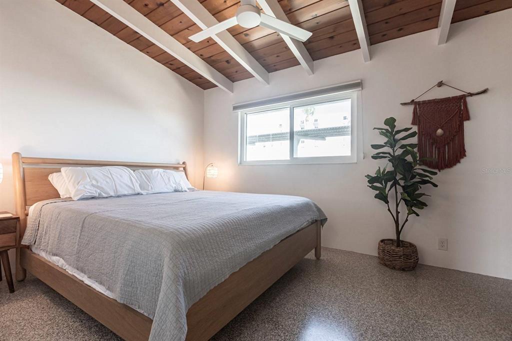 6006 Midnight Pass Road, Unit 53 Sarasota, FL 34242 - Photo 7 of 20 a bedroom with a bed window and potted plant