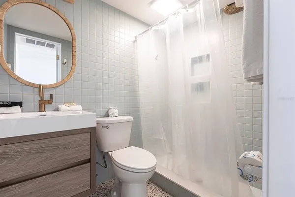 a bathroom with a sink toilet and shower