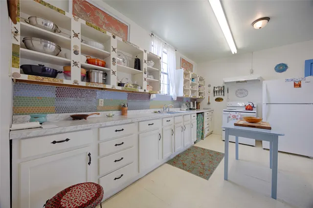 a kitchen with cabinets and window