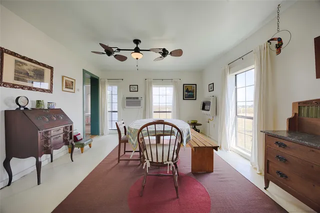 a living room with furniture piano and a window