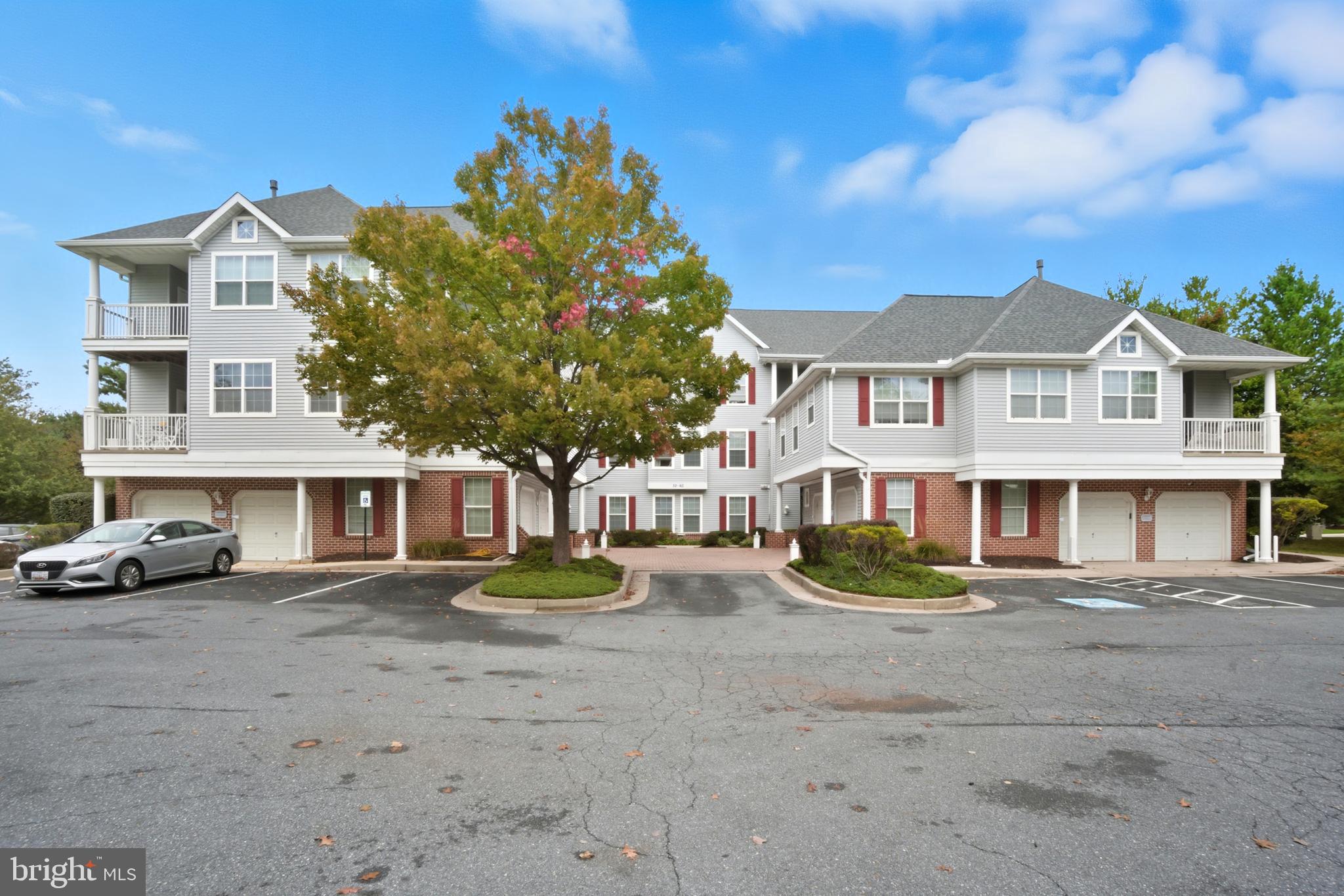 a front view of a residential apartment building with a yard