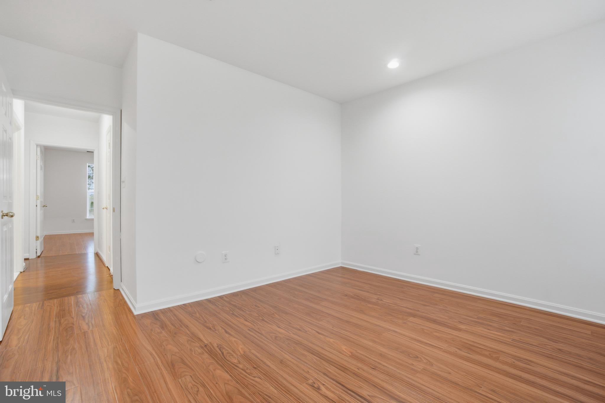 34 Hawk Rise Lane, Unit 103 Owings Mills, MD 21117 - Photo 24 of 29 wooden floor in a hall with an empty room