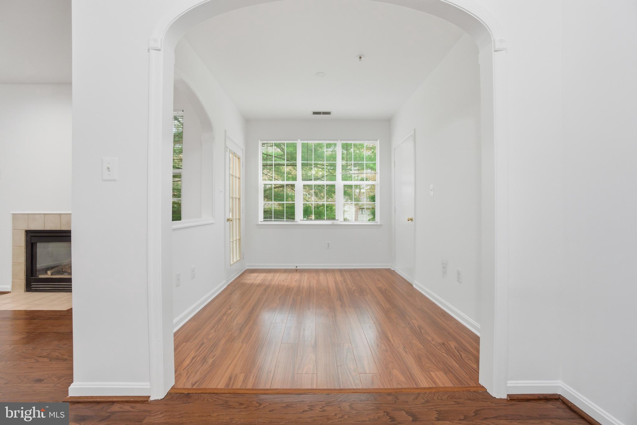 34 Hawk Rise Lane, Unit 103 Owings Mills, MD 21117 - Photo 8 of 29 an empty room with wooden floor and windows