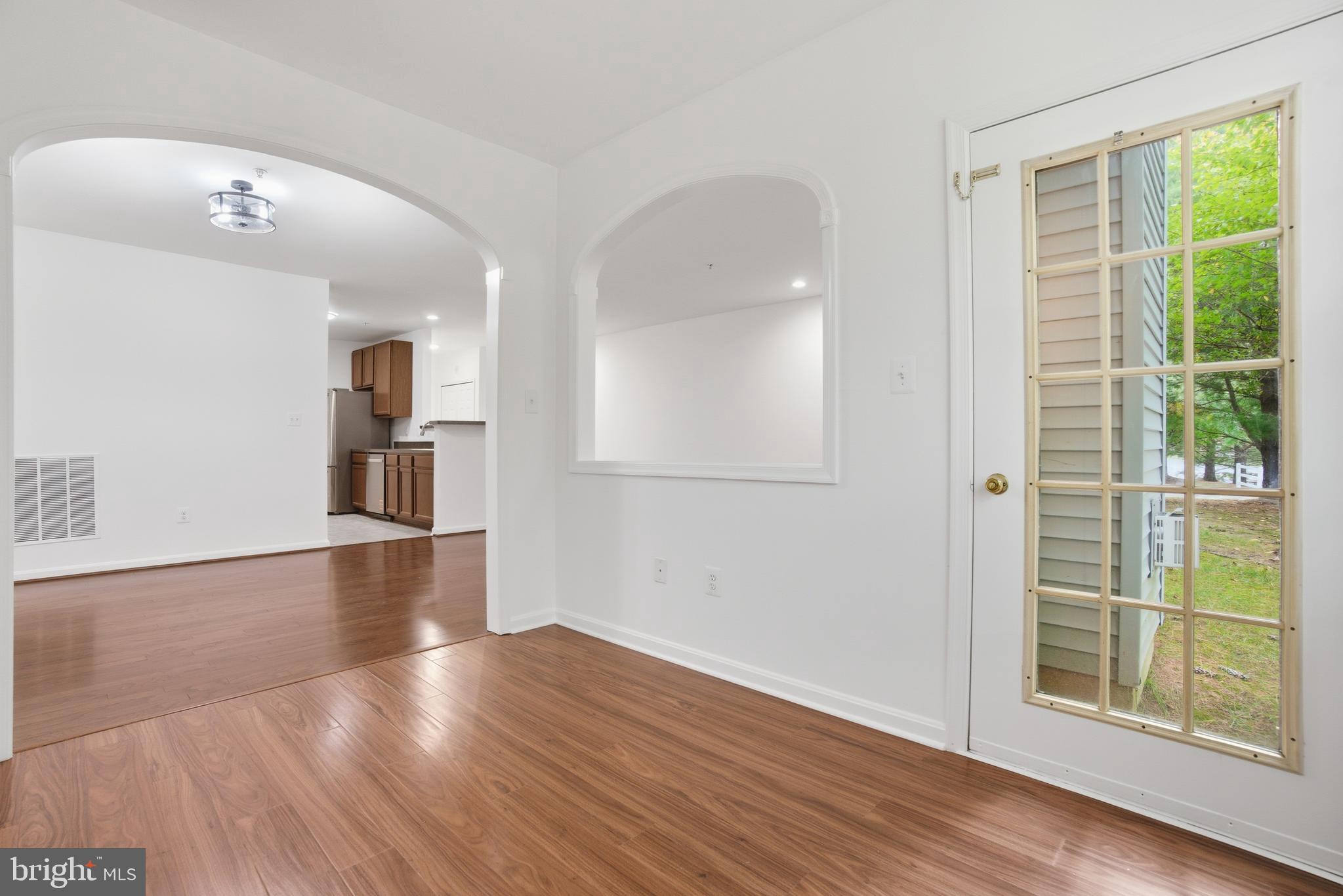 34 Hawk Rise Lane, Unit 103 Owings Mills, MD 21117 - Photo 9 of 29 a view of empty room with wooden floor and fan