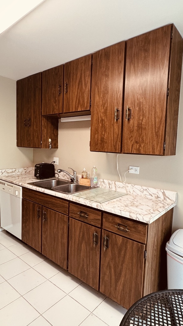 1714 Northfield Square, Unit F Northfield, IL 60093 - Photo 8 of 18 a kitchen with granite countertop stainless steel appliances wooden cabinets a sink and a stove