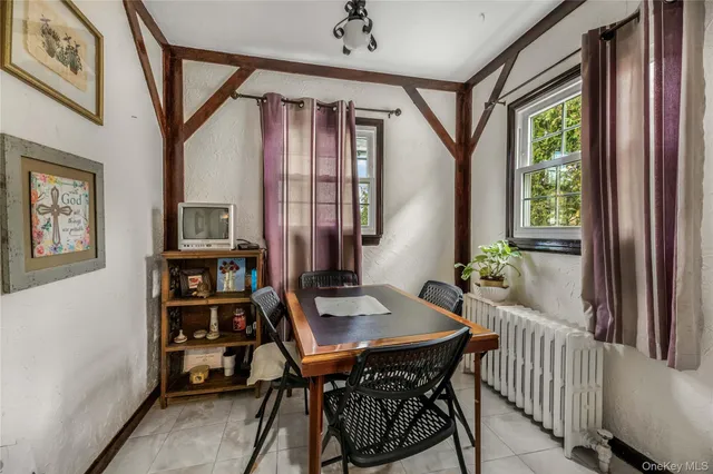 a view of a dining room with furniture and a window