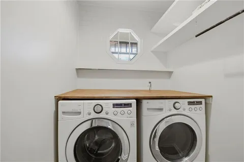 a view of washer and dryer with kitchen in the background