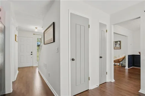 a view of a hallway with wooden floor