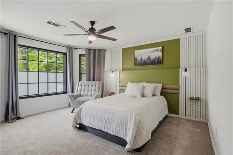 a bedroom with a bed and a large window