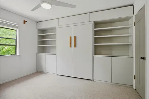 a view of walk in closet with empty racks