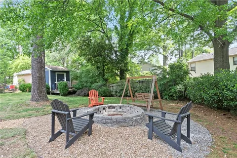 a view of a yard with furniture and garden