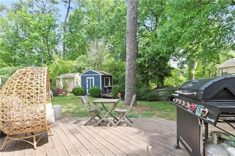 a view of a chair and table on the wooden deck