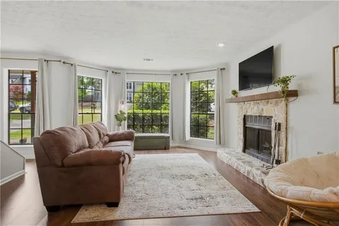 a living room with furniture flat screen tv and a fireplace