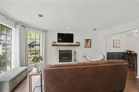 a living room with furniture a fireplace and a flat screen tv
