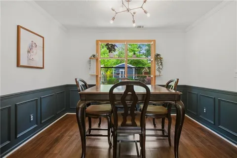 a view of a dining room with furniture window and wooden floor