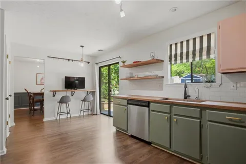 a kitchen with a sink cabinets and wooden floor