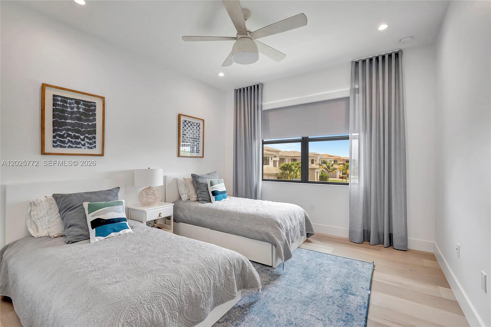 17023 Wandering Wave Avenue Boca Raton, FL 33496 - Photo 40 of 84 a bedroom with two beds and a window