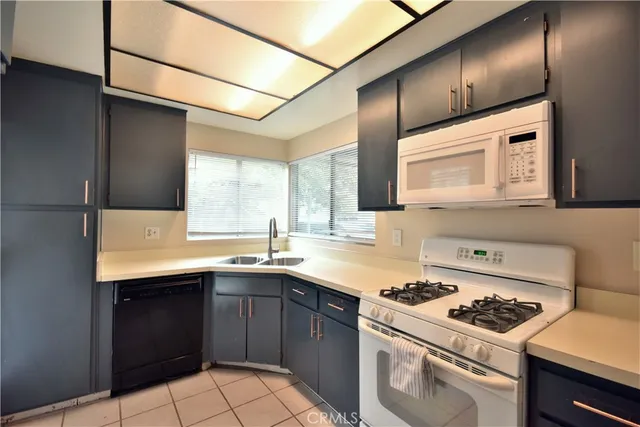 a kitchen with a sink a stove and cabinets