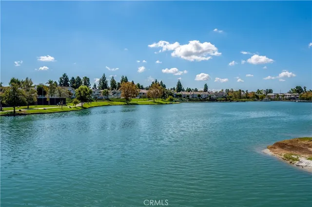 a view of a lake with houses in the background