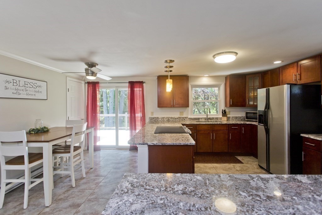 15 Circle Drive Wilbraham, MA 01095 - Photo 24 of 42 a kitchen with stainless steel appliances granite countertop a refrigerator a sink dishwasher a dining table and chairs with wooden floor