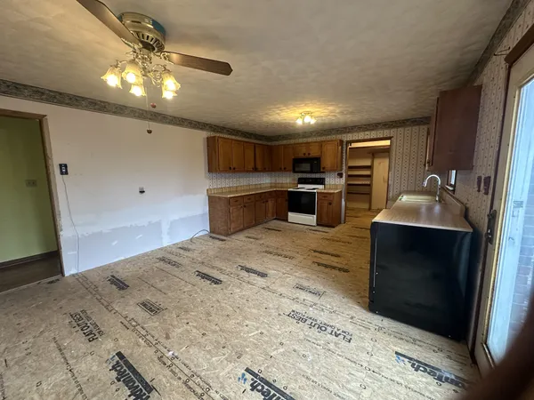 a kitchen with refrigerator and window
