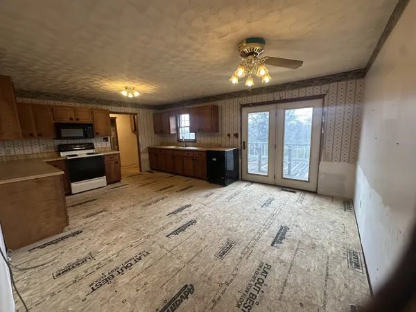 a large kitchen with kitchen island granite countertop lots of counter space a sink and dishwasher