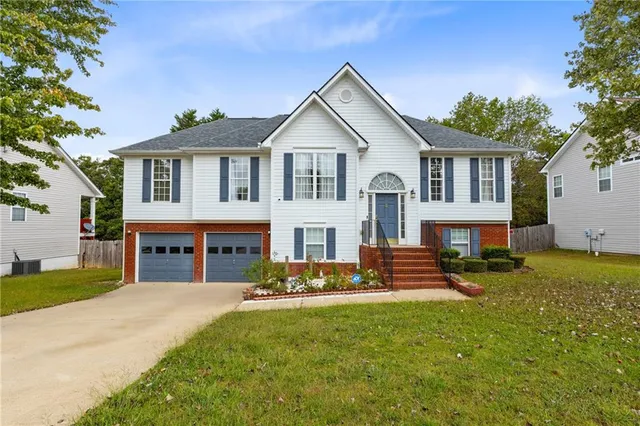 a front view of a house with a yard