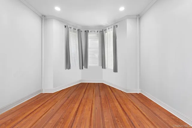 a view of a room with wooden floor and fan
