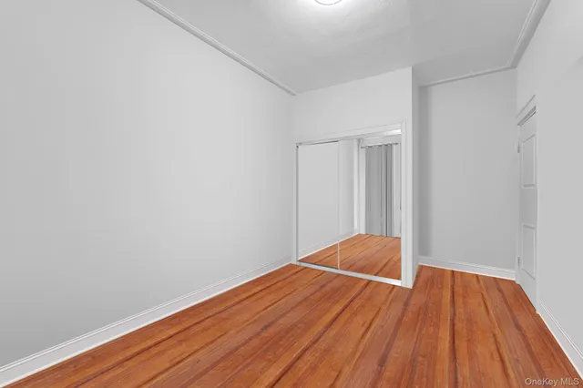 a room with wooden floor and closet