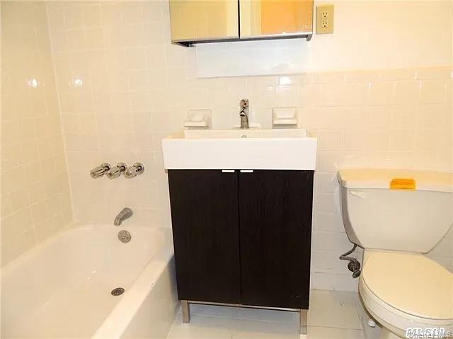 103-17 Plattwood Avenue Queens, NY 11417 - Photo 24 of 25 a bathroom with a sink a toilet and shower