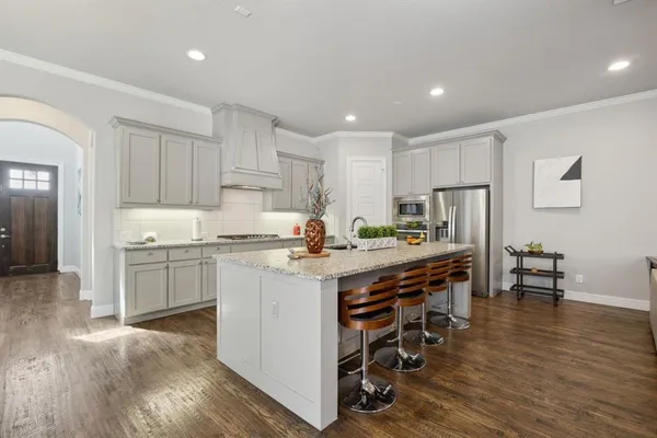 a kitchen with a sink a counter top space and stainless steel appliances