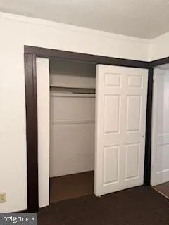 a view of a room with an empty space and a ceiling fan