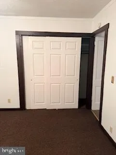 a view of a closet area with an empty door