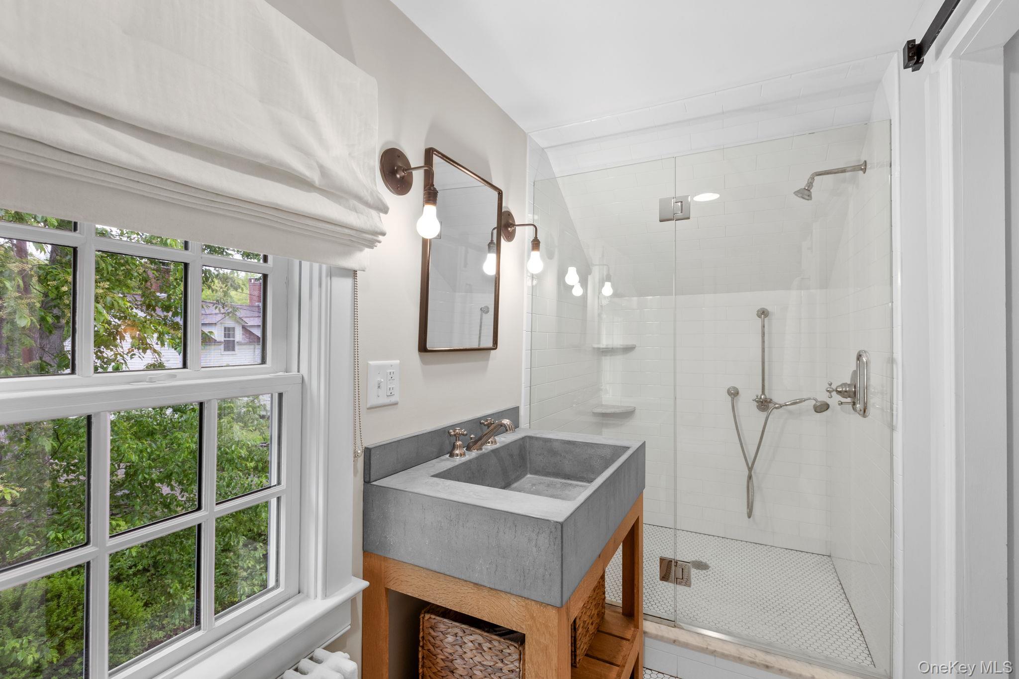 23 Pound Ridge Road Pound Ridge, NY 10576 - Photo 24 of 40 a bathroom with a sink and a mirror