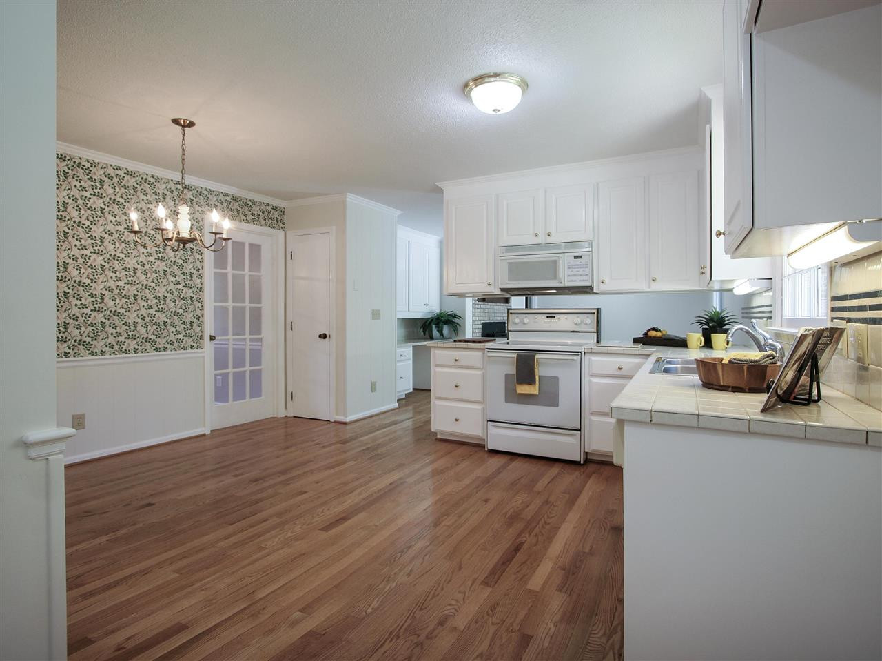 1324 Kingston Ridge Road Cary, NC 27511 - Photo 10 of 30 Overall view of the kitchen and breakfast area, and the family room beyond. Note the glass door to the dining room and the convenient location of the pantry. Kitchen