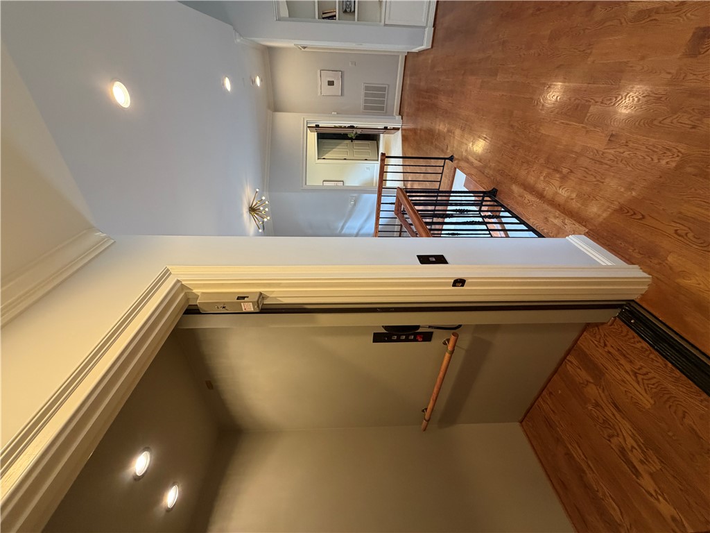 357 Stardust Lane Seneca, SC 29672 - Photo 9 of 50 Elevator- Rich hardwood floors and elegant crown molding flow past a private home elevator.