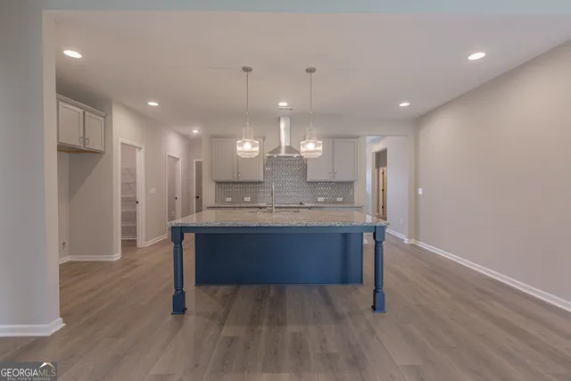 a view of kitchen with refrigerator microwave and wooden floor