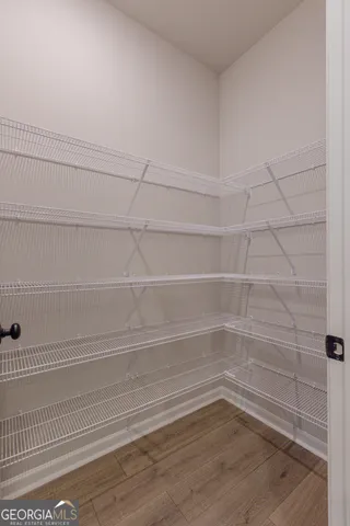 an empty room with wooden floor and fireplace