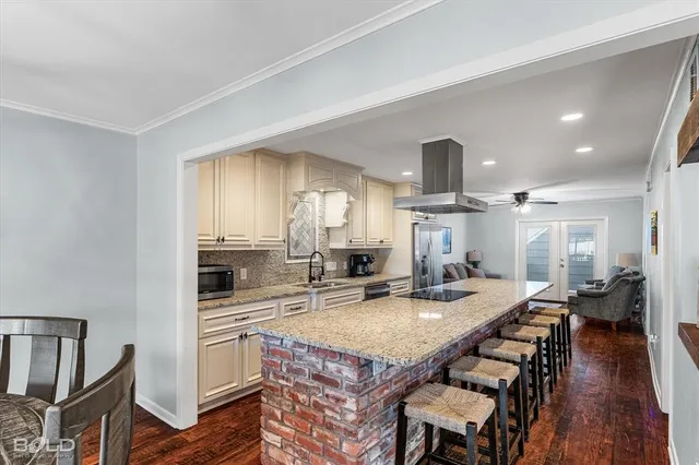 a open kitchen with sink cabinets and wooden floor
