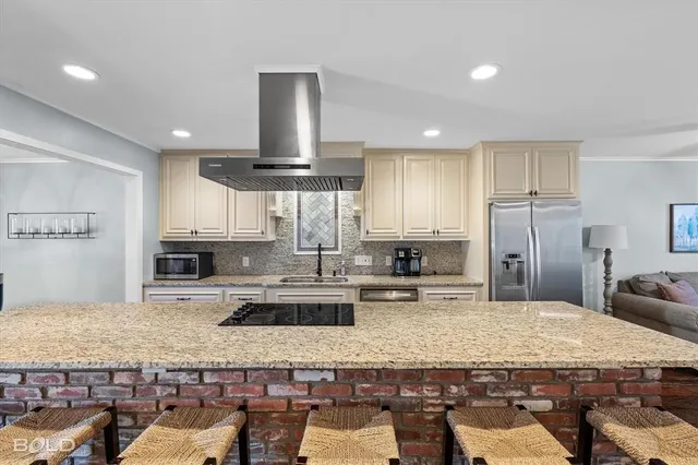 a kitchen with kitchen island granite countertop a sink and counter space