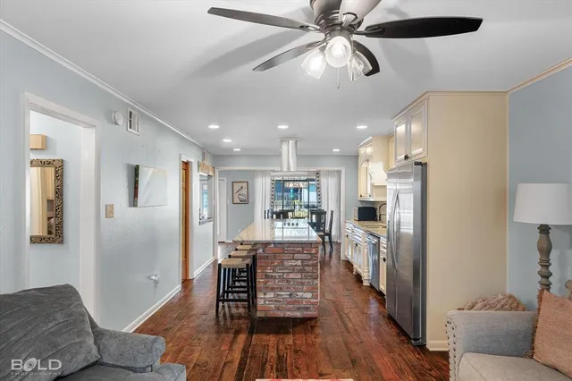 a view of a kitchen with furniture and wooden floor