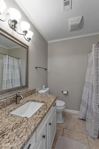 a bathroom with a granite countertop sink a toilet and a mirror